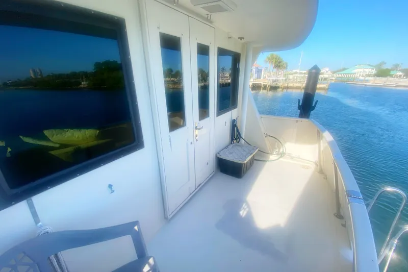 Slide: The Image of 1983 Hatteras 53 Motor Yacht deck with waterfront view and clear blue sky. - 19