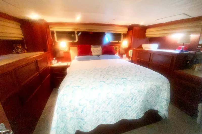 Slide: The Image of Luxurious bedroom interior of 1983 Hatteras 53 Motor Yacht with cozy bedding and warm lighting. - 36