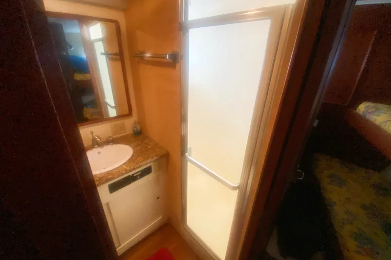 Slide: The Image of 1983 Hatteras 53 Motor Yacht bathroom with sink, mirror, and shower. - 30