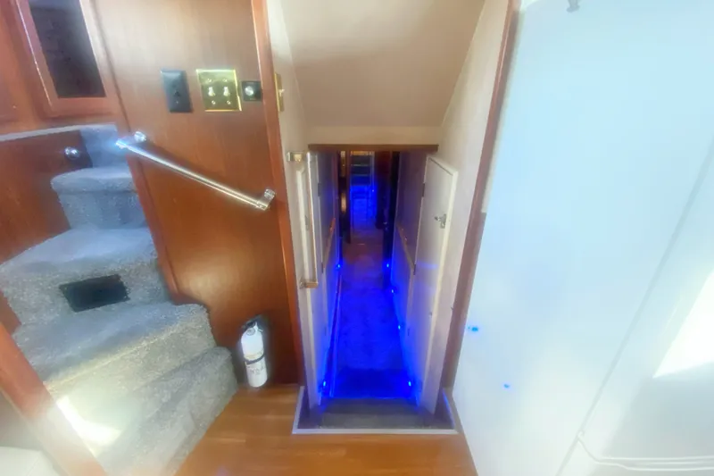 Slide: The Image of Interior view of 1983 Hatteras 53 Motor Yacht with illuminated hallway and stairs. - 32