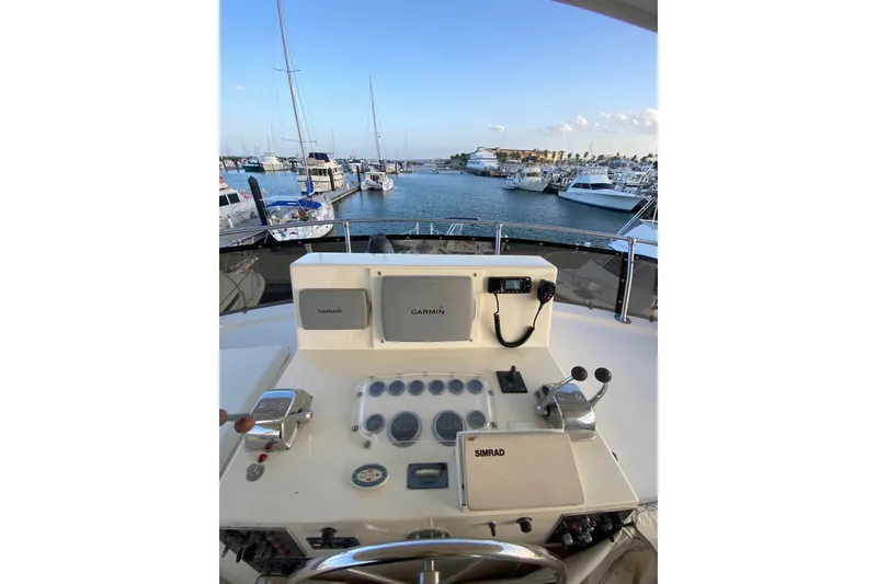 Slide: The Image of Cockpit view of 1983 Hatteras 53 Motor Yacht with navigation equipment, docked at marina. - 49
