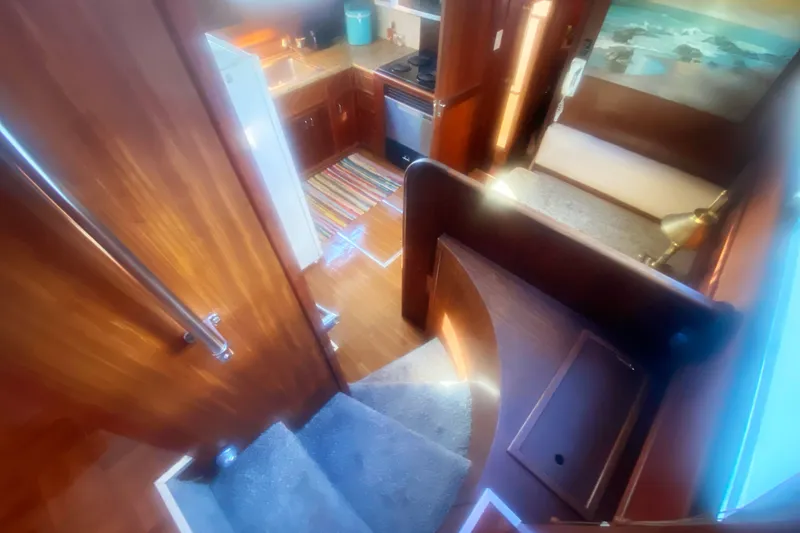 Slide: The Image of Interior view of 1983 Hatteras 53 Motor Yacht, featuring kitchen and cozy living area. - 21