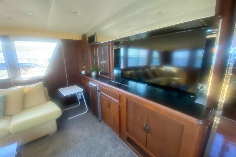 Slide: The Image of Interior of 1983 Hatteras 53 Motor Yacht with TV, sofa, and wooden cabinetry. - 16