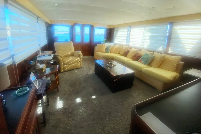 Slide: The Image of Luxurious interior of 1983 Hatteras 53 Motor Yacht with plush seating and elegant decor. - 14