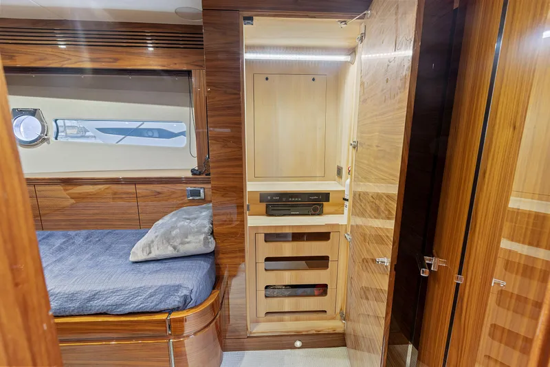 Slide: The Image of Sunseeker Predator 68 2015 yacht interior cabin with bed and wooden storage. - 33