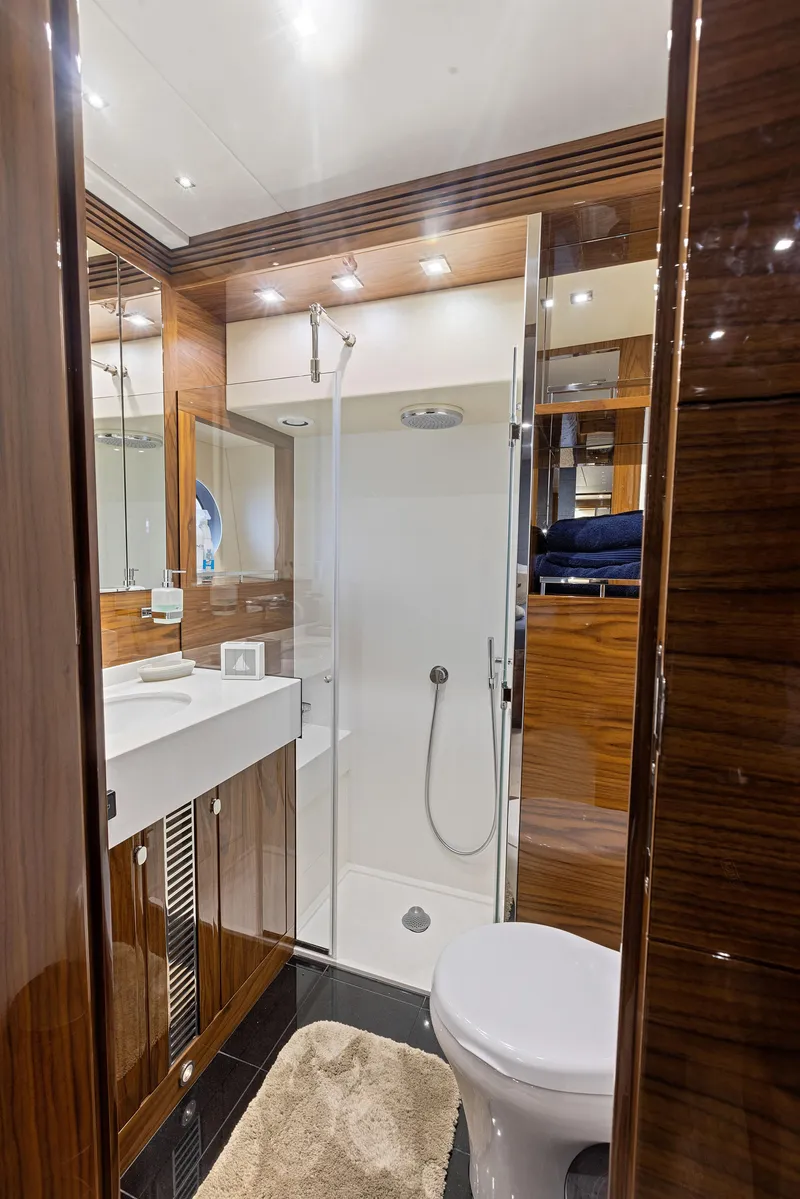Slide: The Image of Luxurious bathroom in 2015 Sunseeker Predator 68 yacht with modern fixtures and wooden accents. - 34