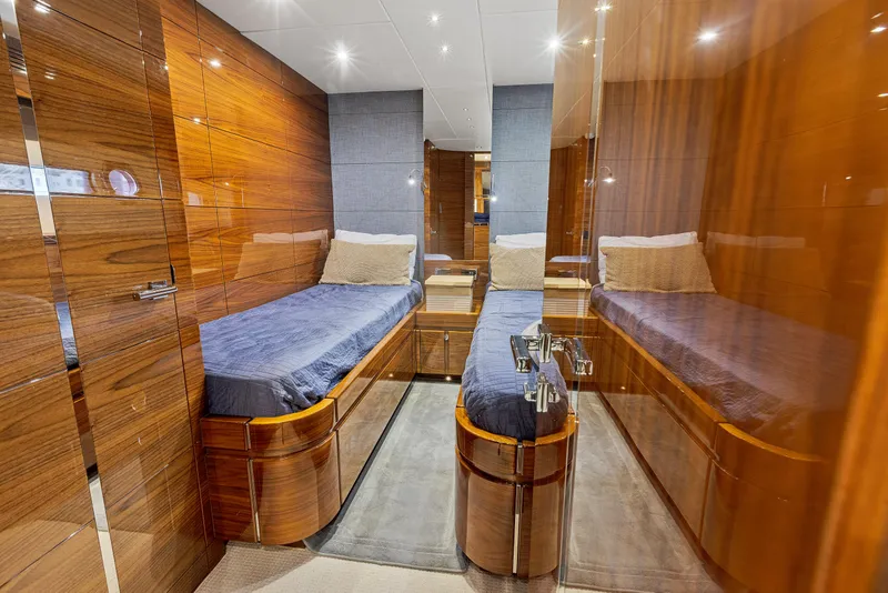 Slide: The Image of Sunseeker Predator 68 2015 twin cabin with wooden finish and blue bedding. - 32