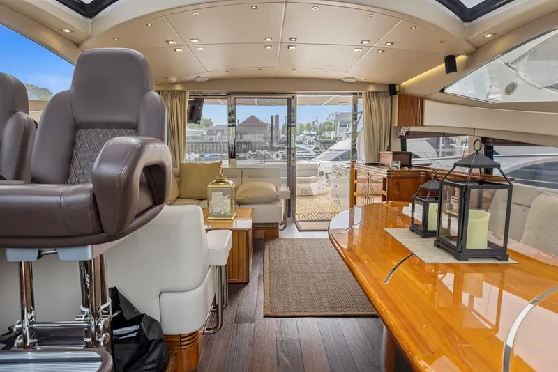 Slide: The Image of Luxurious interior of 2015 Sunseeker Predator 68 yacht with elegant seating and wooden table. - 16