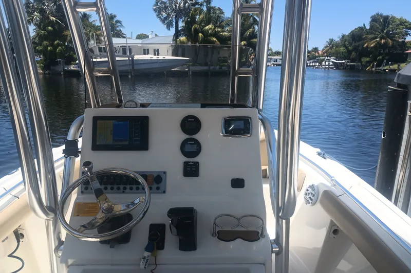 Slide: The Image of 2018 Key West 219 FS boat dashboard with steering wheel and navigation equipment. - 19