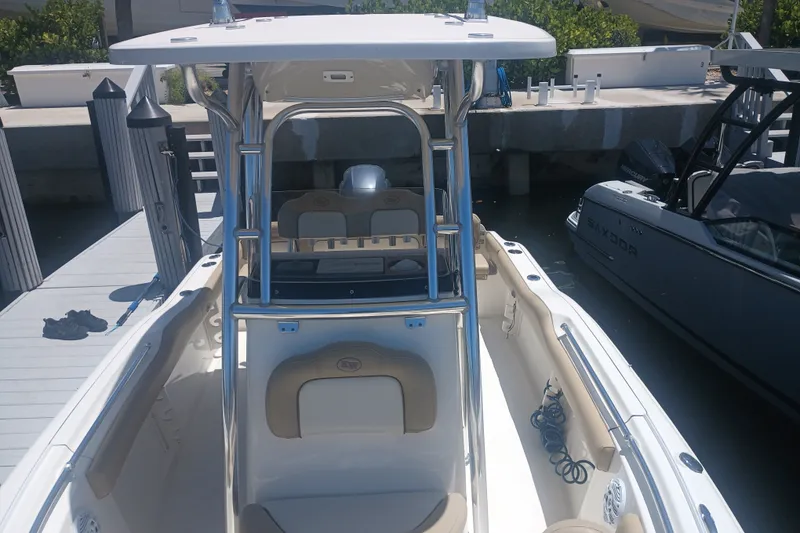 Slide: The Image of 2018 Key West 219 FS boat docked, featuring sleek design and spacious seating. - 16