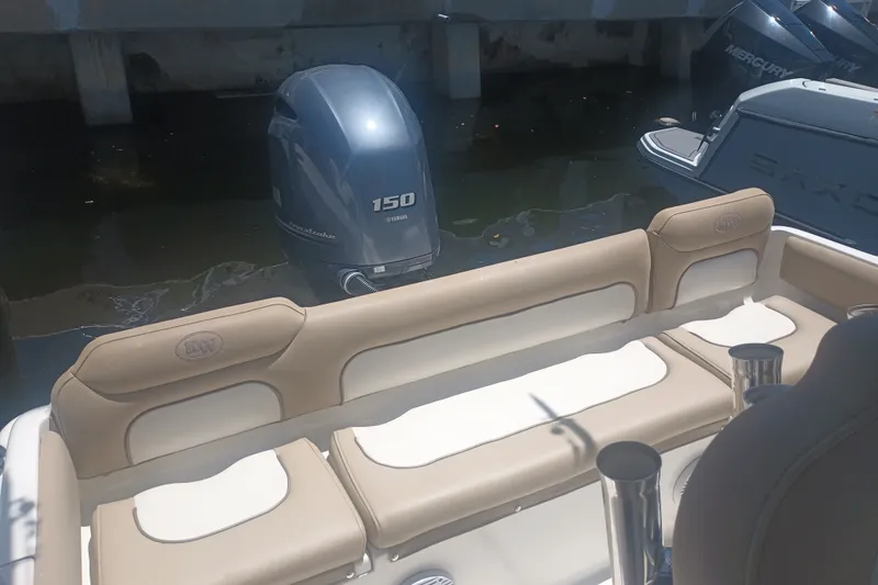 Slide: The Image of 2018 Key West 219 FS boat with Yamaha 150 outboard motor, docked in sunlight. - 13