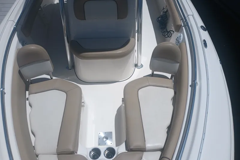 Slide: The Image of 2018 Key West 219 FS boat interior with beige seating and stainless steel accents. - 22