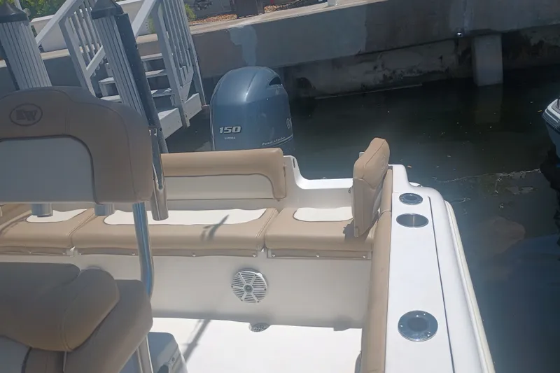 Slide: The Image of 2018 Key West 219 FS boat with Yamaha 150 engine docked by stairs. - 17