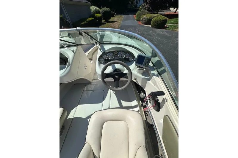 Slide: The Image of 2005 Sea Ray 180 Sport boat cockpit with steering wheel and dashboard controls. - 6