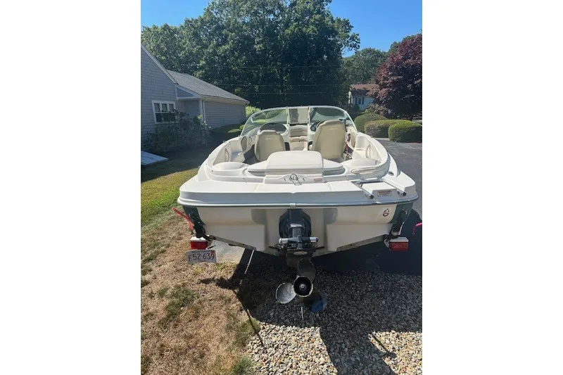 Slide: The Image of 2005 Sea Ray 180 Sport boat parked on gravel driveway, rear view. - 4
