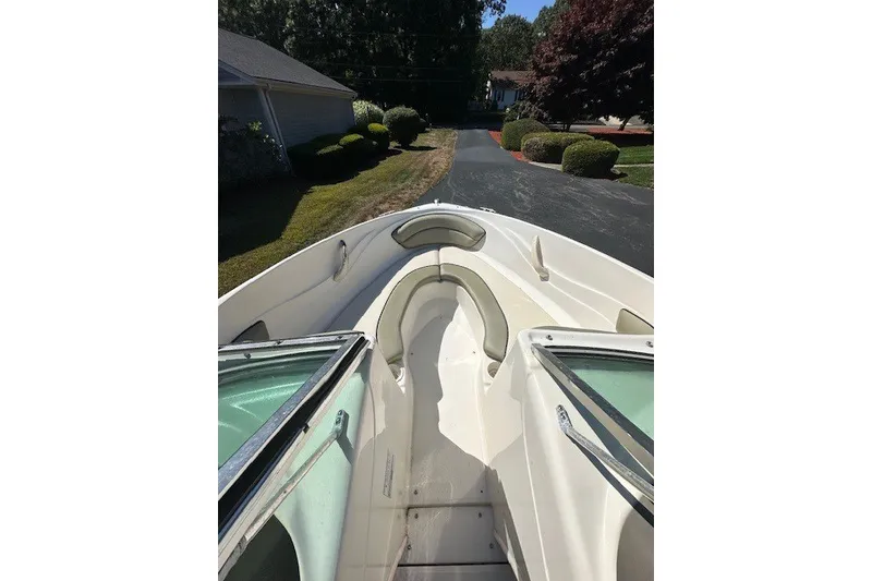 Slide: The Image of 2005 Sea Ray 180 Sport boat, white interior, parked on a driveway. - 7