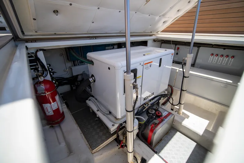 Slide: The Image of Engine compartment of 2022 Wally wallytender43X with Kohler generator and fire extinguisher. - 29