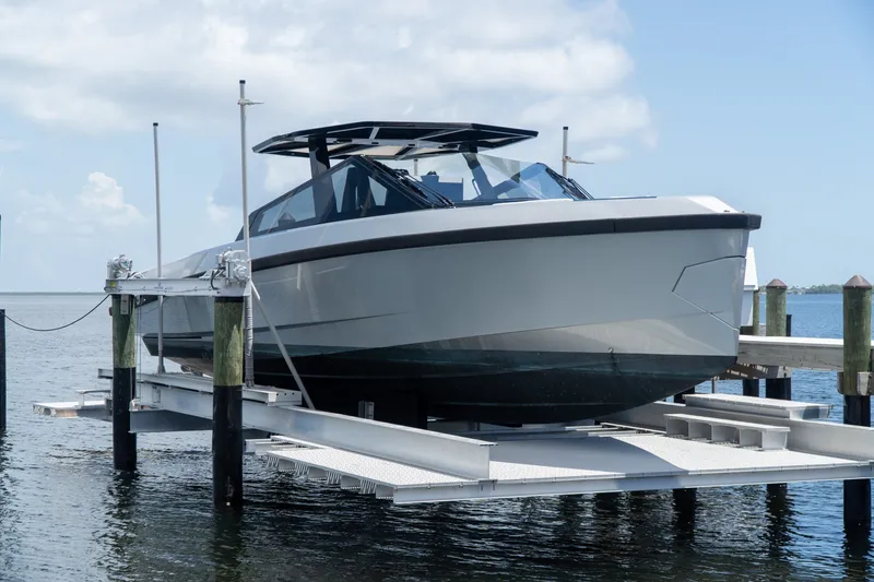 Slide: The Image of 2022 Wally wallytender43X yacht on lift, docked by the water. - 2