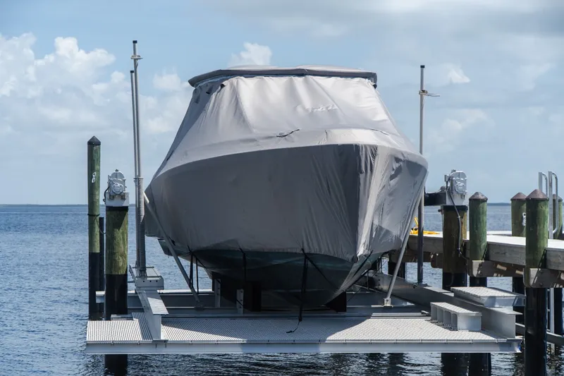 Slide: The Image of Covered 2022 Wally wallytender43X boat on dock lift by the water. - 4