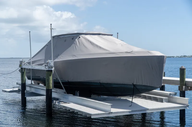 Slide: The Image of Covered 2022 Wally wallytender43X boat on a lift by the water. - 5
