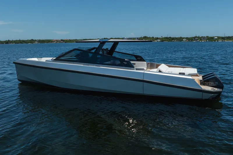 Slide: The Image of 2022 Wally wallytender43X luxury boat on calm water, sleek design, sunny day. - 43