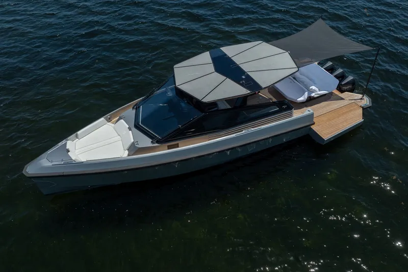 Slide: The Image of 2022 Wally wallytender43X luxury yacht on calm water, featuring sleek design and sunshade. - 65