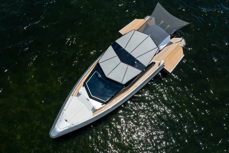 Slide: The Image of 2022 Wally wallytender43X yacht on water, aerial view showcasing sleek design and sunshade. - 64