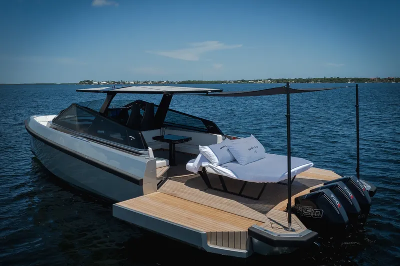 Slide: The Image of Luxury 2022 Wally wallytender43X yacht on serene blue water, featuring sleek design and sunbathing area. - 74