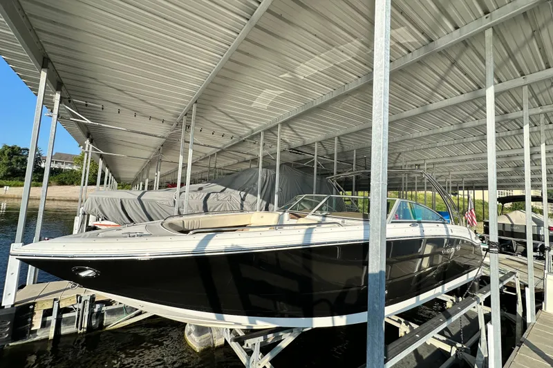 Slide: The Image of 2010 Cobalt 296 boat docked under covered marina. - 4
