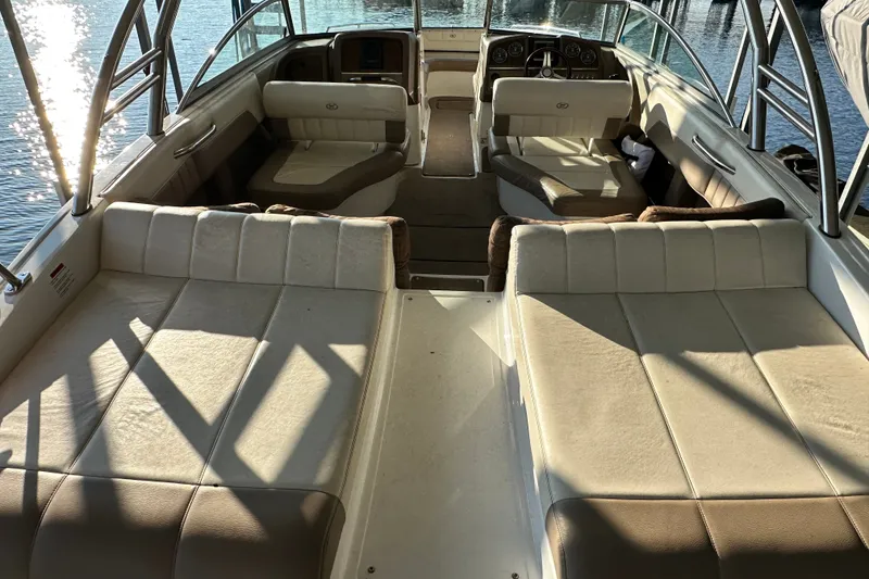 Slide: The Image of Interior of a 2010 Cobalt 296 boat with beige seating and water view. - 8