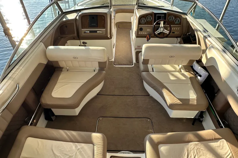 Slide: The Image of Interior of a 2010 Cobalt 296 boat with beige seating and steering console. - 9