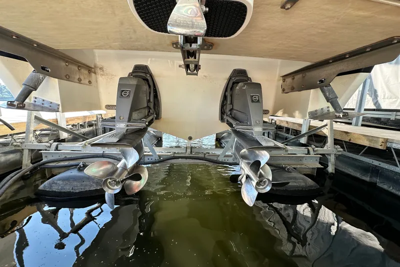 Slide: The Image of 2010 Cobalt 296 boat with dual propellers in a marina setting. - 24