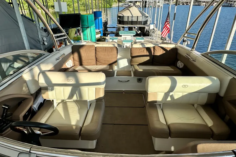 Slide: The Image of Luxurious 2010 Cobalt 296 boat interior with plush seating, docked by a serene lake. - 18