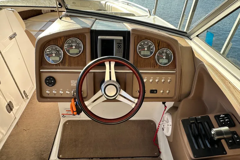 Slide: The Image of 2010 Cobalt 296 boat dashboard with gauges, steering wheel, and controls. - 15