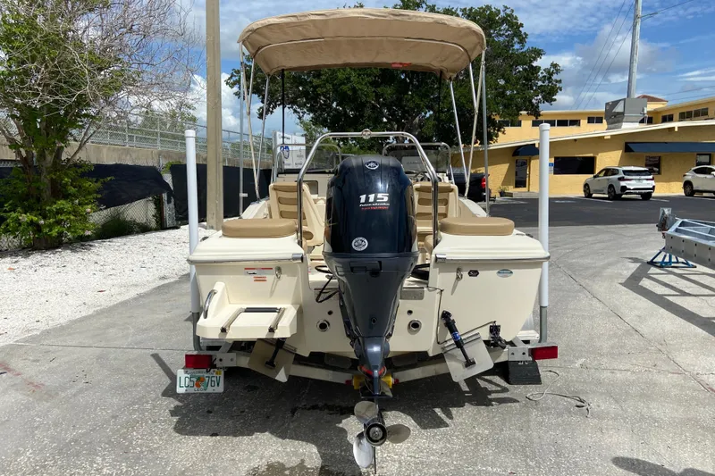 Slide: The Image of 2021 Scout 175 Sport Dorado boat with Yamaha 115 outboard motor, parked outdoors. - 3