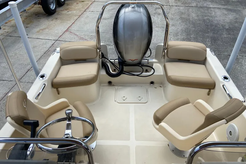 Slide: The Image of 2021 Scout 175 Sport Dorado boat interior with beige seating and steering wheel. - 6