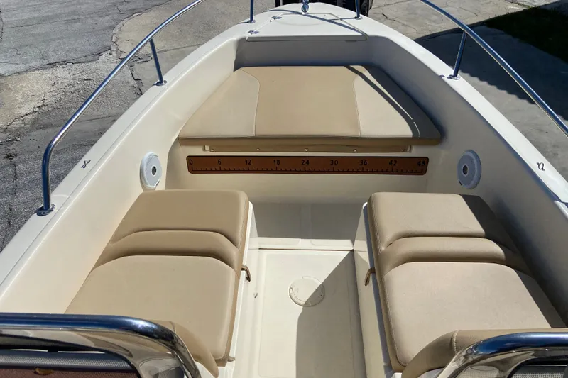 Slide: The Image of 2021 Scout 175 Sport Dorado boat interior with beige seating and measurement markings. - 12
