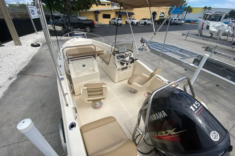 Slide: The Image of 2021 Scout 175 Sport Dorado boat with Yamaha 115 engine, docked outdoors. - 4
