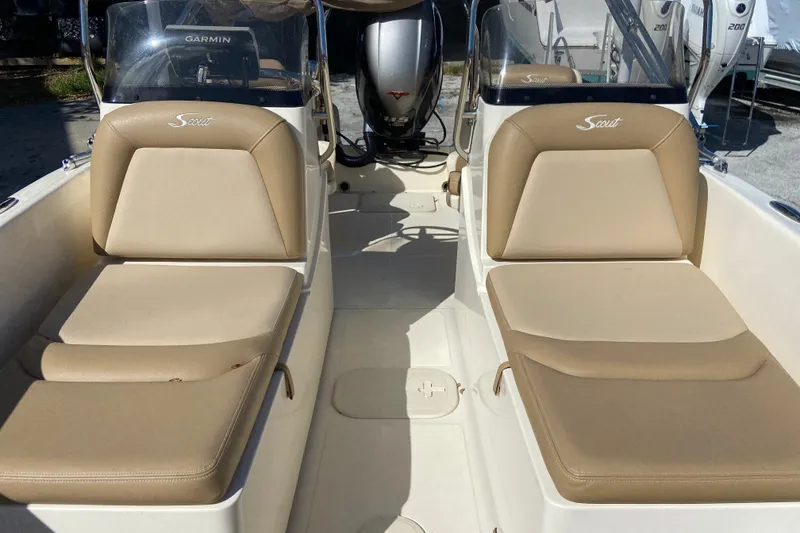 Slide: The Image of 2021 Scout 175 Sport Dorado boat interior with beige seating and Garmin equipment. - 14