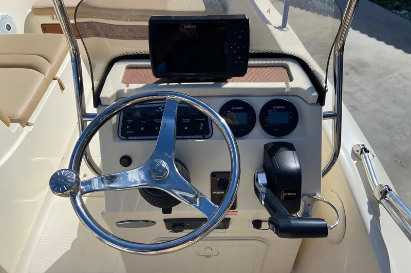 Slide: The Image of 2021 Scout 175 Sport Dorado boat dashboard with steering wheel and Garmin display. - 8