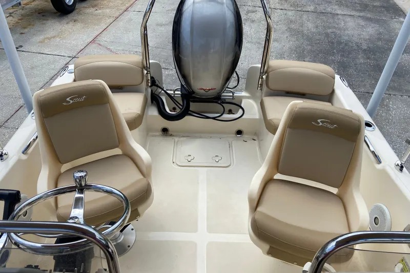 Slide: The Image of 2021 Scout 175 Sport Dorado boat interior with beige seating and steering wheel. - 5