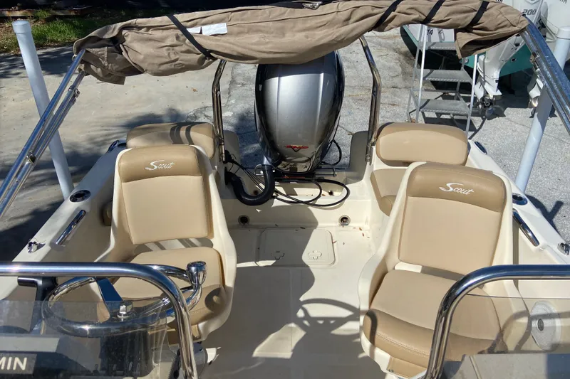 Slide: The Image of 2021 Scout 175 Sport Dorado boat interior with beige seating and motor. - 5
