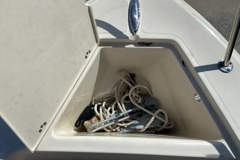 Slide: The Image of Open storage compartment on 2021 Scout 175 Sport Dorado boat with ropes and anchor. - 18