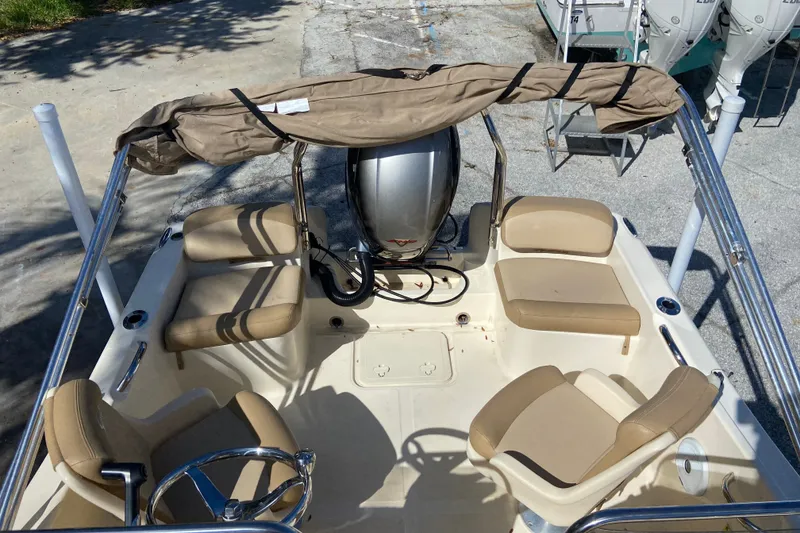 Slide: The Image of 2021 Scout 175 Sport Dorado boat interior with beige seating and steering wheel. - 6