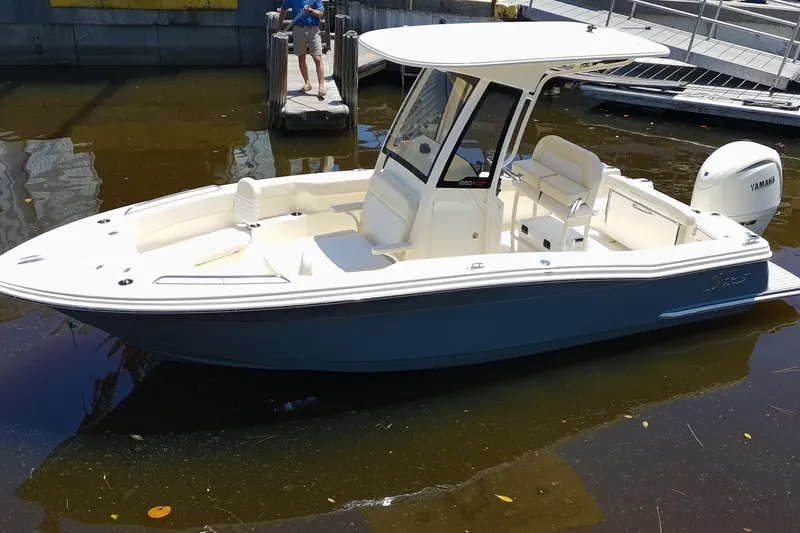 Slide: The Image of 2027 Scout 220 XSF boat docked, featuring sleek design and Yamaha outboard motor. - 1