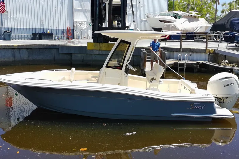 The Image of 2027 Scout 220 XSF boat docked with Yamaha outboard motor in marina setting. - 0