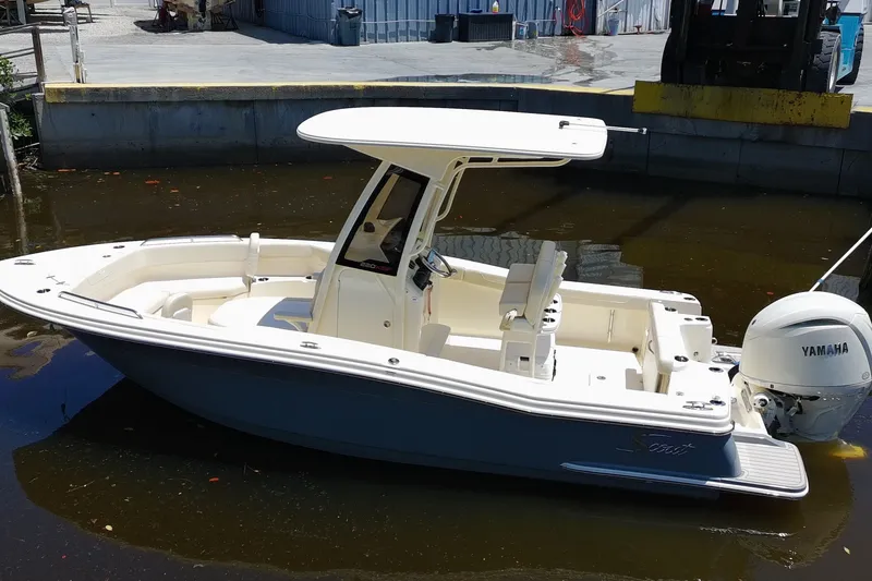 Slide: The Image of 2027 Scout 220 XSF boat with Yamaha engine docked in a marina. - 3