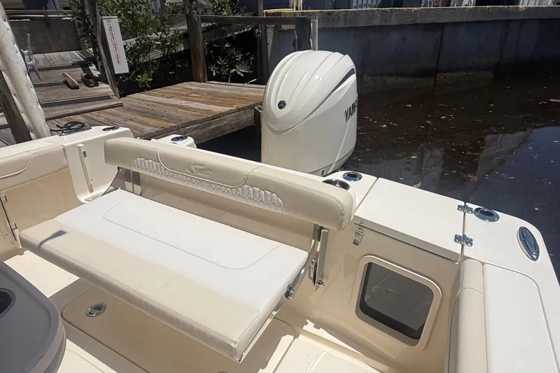 Slide: The Image of 2027 Scout 220 XSF boat interior with Yamaha outboard motor at dock. - 12
