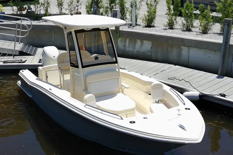 Slide: The Image of 2027 Scout 220 XSF boat docked at marina, featuring sleek design and modern amenities. - 5