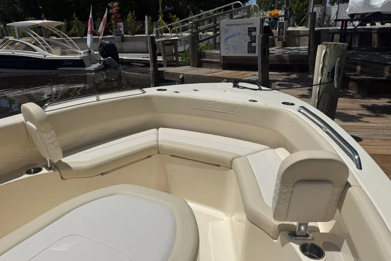 Slide: The Image of Interior view of 2027 Scout 220 XSF boat at dockside, featuring comfortable seating. - 16